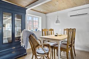 a dining room with a wooden table and chairs at 20313-Samso-Orby-Hovedgade-53 in Brundbymark
