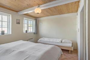 a bedroom with a bed and a window at 20313-Samso-Orby-Hovedgade-53 in Brundbymark