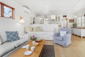 a living room with a couch and a table at 20132-Samso-Skovvejen-7 in Nordby