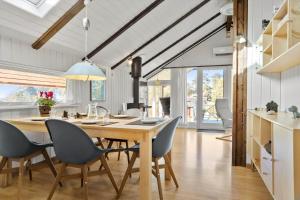 a kitchen and dining room with a table and chairs at 20223-Samso-Rosenvej-8 in Tanderup +25 photos