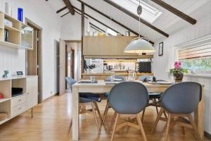 a kitchen and dining room with a table and chairs at 20223-Samso-Rosenvej-8 in Tanderup