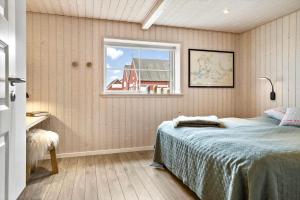 a bedroom with a bed and a window at 20123-Samso-Maarup-Havn-7-A in Nordby