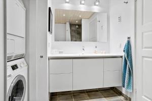 a white bathroom with a sink and a washing machine at 20123-Samso-Maarup-Havn-7-A in Nordby +21 photos