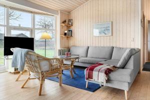 a living room with a couch and a table at 20411-Samso-Nylandsvej-21-C in Ballen