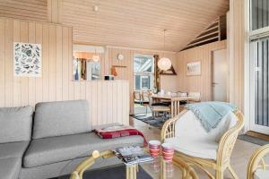 a living room with a couch and a table at 20411-Samso-Nylandsvej-21-C in Ballen +29 photos