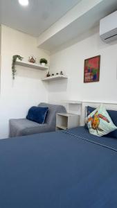 a bedroom with two beds with blue sheets at Mai Khao 777 Beach Condo in Ban Mai Salae