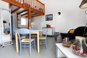 a kitchen and living room with a table and chairs at Les Portes de la Méouge anciennement Le Serpolet in Séderon