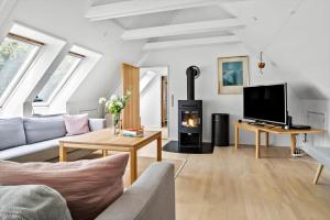a living room with a couch and a fireplace at 20509-Samso-Egevej-13 in Onsbjerg
