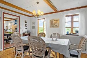 a dining room with a table and chairs at 20206-Samso-Haardmark-Mark-7 in Kolby Kås +20 photos