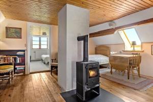 a living room with a wood stove in a room at 20206-Samso-Haardmark-Mark-7 in Kolby Kås