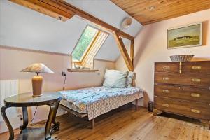 a bedroom with a bed and a table and a window at 20206-Samso-Haardmark-Mark-7 in Kolby Kås