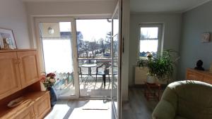 a living room with a door leading to a patio at FW Wölfer in Velten