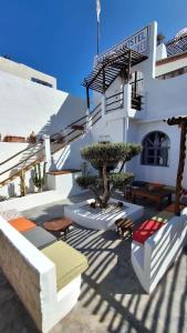 a white building with a tree in front of it at L'auberge des Vagues in Sidi Kaouki