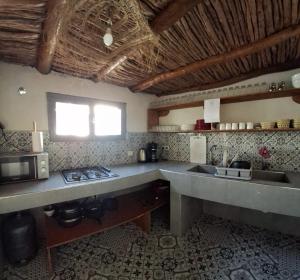 a kitchen with a counter top and a sink at L'auberge des Vagues in Sidi Kaouki