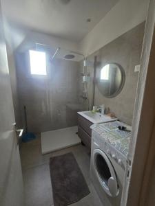 a bathroom with a sink and a washing machine at villa gambotti in Morta +6 photos