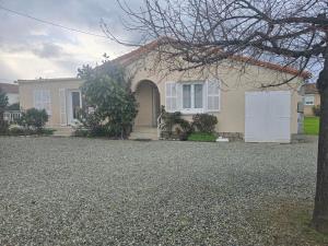a house with a gravel driveway in front of it at villa gambotti in Morta