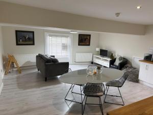 a living room with a table and a couch at Townhouse Apartment in Oswestry