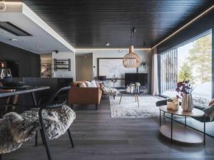 a living room with a couch and a table at Arctic Aurora Hideaway in Rovaniemi