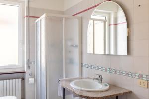 a bathroom with a sink and a mirror and a shower at Trilocale Ferruccio in Baveno +22 photos