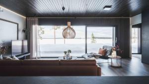 a living room with a couch and a large window at Arctic Aurora Hideaway in Rovaniemi