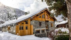 a house with snow on the roof of it at Le Thuria in Sainte-Foy-Tarentaise