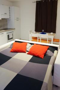 a bed with colorful pillows on it in a room at Ca di baragett in Mandello del Lario
