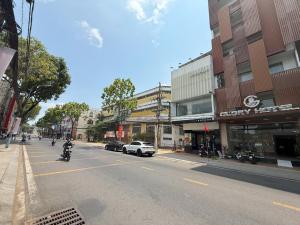 a person riding a motorcycle down a city street at Glory Hotel in Can Tho