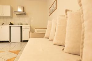 a white couch in a room with a kitchen at Dimani Suites & Residences in Gythio