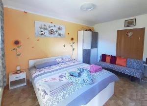a small bedroom with a bed and a couch at Hiša Planica in Kobarid