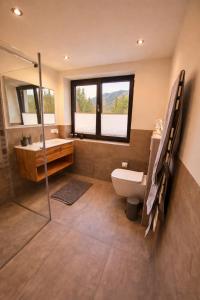 a bathroom with a tub and a toilet and a sink at Tante Maridi in Forstau