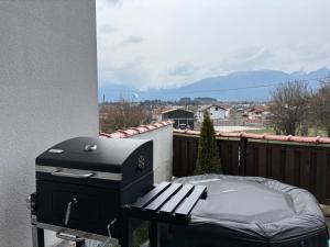 a grill and a picnic table on a balcony at Villa Detelina near the Bansko Ski Resort with Jacuzzi in Razlog