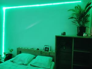 a room with a bed with a blue light at La chambre zen in Saint-André