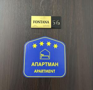 a blue sign for an airport appointment on a wall at Apartmani Fontana Banja Koviljaca in Banja Koviljača