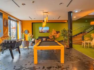 a living room with a ping pong table in it at ibis Styles Calais Centre in Calais