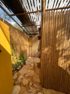 a patio with a wooden fence and a bench at Meek Yurt in Yodefat +4 photos