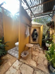 an outdoor bathroom with a toilet and a window at Meek Yurt in Yodefat