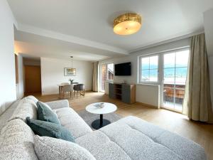 a living room with a couch and a table at Hotel Garni Buchinger in St. Wolfgang