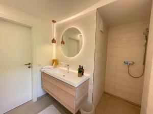 a bathroom with a sink and a mirror at Hotel Garni Buchinger in St. Wolfgang +38 photos