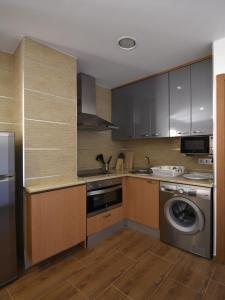 a kitchen with a washing machine and a washer at Apartamentos La Rocanda in Coca