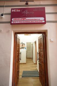 a sign hanging over a door in a hallway at Shiv Kothi Home Stay in Varanasi