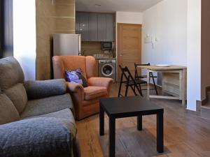 a living room with a couch and chairs and a table at Apartamentos La Rocanda in Coca