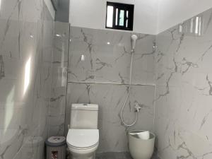 a bathroom with a toilet and a shower at Beachfront Sunset Getaway in Allen +3 photos