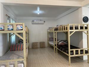 a room with three bunk beds in a room at Beachfront Sunset Getaway in Allen