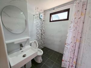 a bathroom with a sink and a toilet and a mirror at M-Well House in Sathani Ban Hua Mak