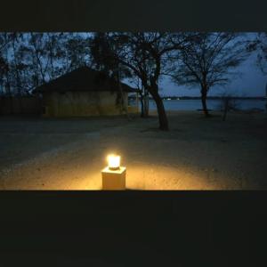a lit candle sitting in the middle of a field at Mar Setal in Mar Lodj