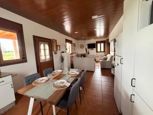 a dining room with a wooden table and chairs at Refugio y Calma in Chantada