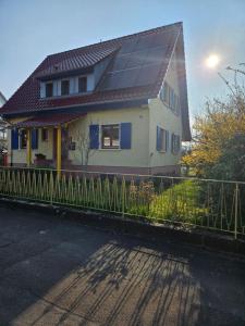 a house with solar panels on top of a fence at Morgensonne in Lahr +8 photos