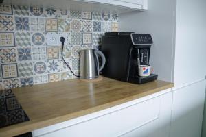 a coffee maker on a counter in a kitchen at APARTAMENT PRZYSTAŃ in Giżycko