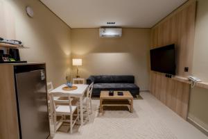 a living room with a couch and a table at Aurion AsSalaam Hotel Apartment in Medina