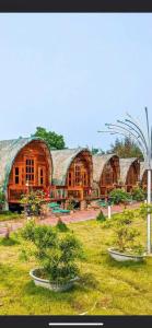 a large building with trees in front of it at Coto Queen in Nam Cap